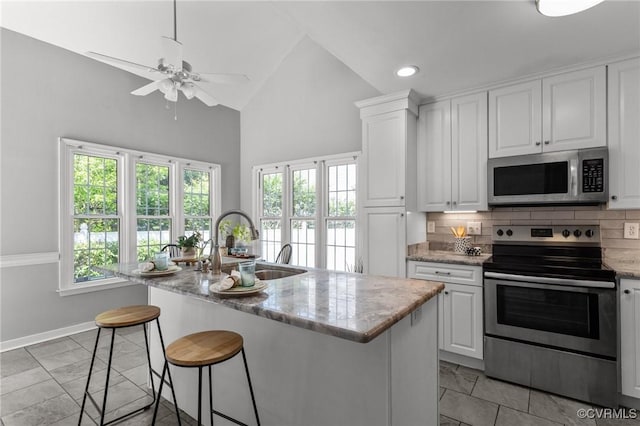 6730 Bryanbell Dr, North Chesterfield, VA 23234 - kitchen with stainless steel appliances, a sink, ceiling fan, tasteful backsplash, and white cabinetry