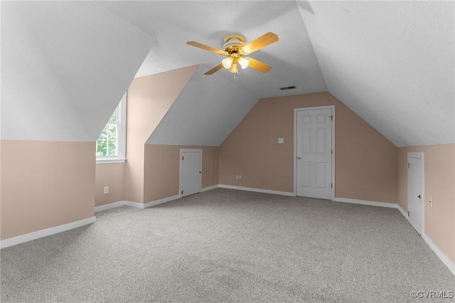 6730 Bryanbell Dr, North Chesterfield, VA 23234 - additional living space with carpet, ceiling fan, lofted ceiling, baseboards, and a textured ceiling