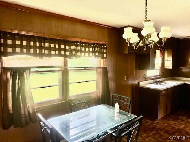 25468 Woodland Park Cir, Courtland, VA 23837 - dining room featuring a chandelier and wood walls