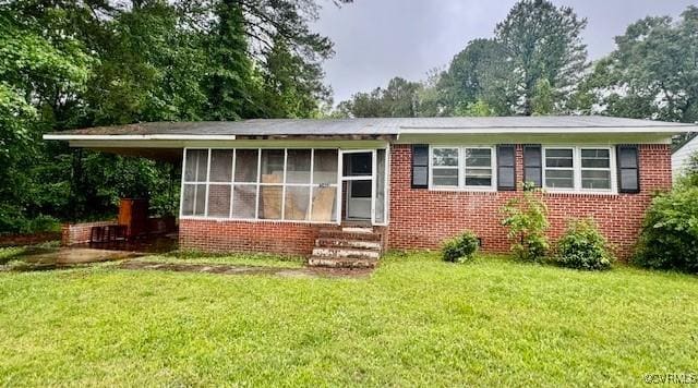 25468 Woodland Park Cir, Courtland, VA 23837 - view of front of property featuring a front lawn, a sunroom, entry steps, and brick siding