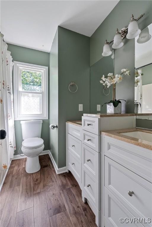 1409 Sycamore Ridge Ct, Midlothian, VA 23114 - bathroom featuring toilet, vanity, wood finished floors, and baseboards