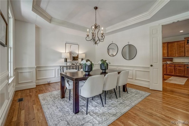 3330 Handley Rd, Midlothian, VA 23113 - dining space featuring ornamental molding, a chandelier, a raised ceiling, light wood-style floors, and a decorative wall