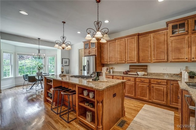 3330 Handley Rd, Midlothian, VA 23113 - kitchen featuring appliances with stainless steel finishes, a chandelier, open shelves, a kitchen island, and brown cabinets