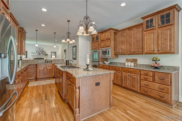 3330 Handley Rd, Midlothian, VA 23113 - kitchen with stainless steel appliances, light wood-style floors, recessed lighting, brown cabinetry, and light stone counters