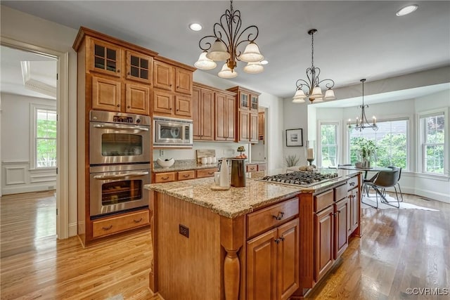 3330 Handley Rd, Midlothian, VA 23113 - kitchen with appliances with stainless steel finishes, a chandelier, light wood-style flooring, brown cabinets, and recessed lighting