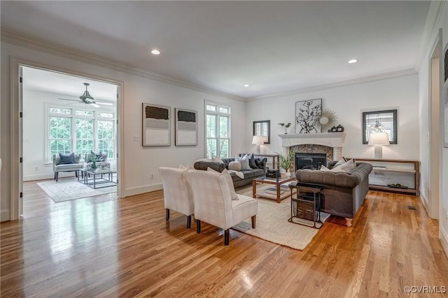 3330 Handley Rd, Midlothian, VA 23113 - living area with light wood-style floors, a glass covered fireplace, plenty of natural light, crown molding, and baseboards