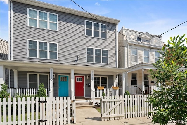 1117 N 31st St, Richmond, VA 23223 - view of front of property featuring covered porch, a gate, and a fenced front yard