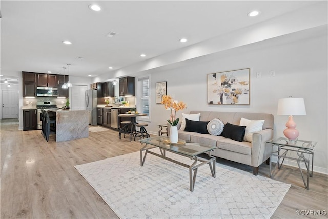 1117 N 31st St, Richmond, VA 23223 - living area featuring light wood-style floors and recessed lighting