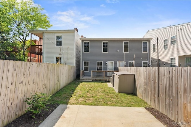 1117 N 31st St, Richmond, VA 23223 - back of property featuring a fenced backyard, a patio area, a wooden deck, and a shed