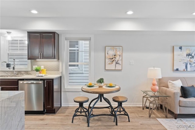 1117 N 31st St, Richmond, VA 23223 - kitchen with dishwasher, dark brown cabinets, light wood-style floors, recessed lighting, and backsplash