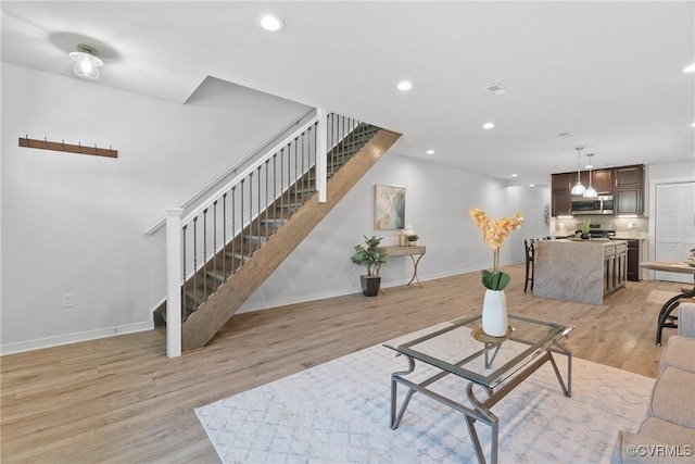 1117 N 31st St, Richmond, VA 23223 - living area featuring stairway, light wood-style floors, and recessed lighting