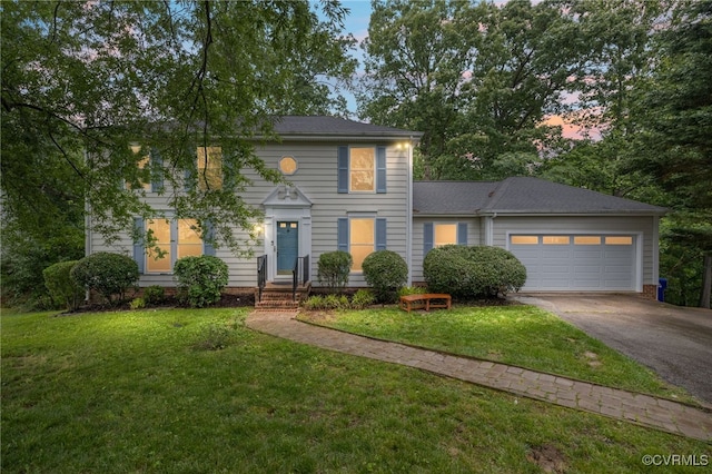 9645 Benbow Rd, North Chesterfield, VA 23235 - colonial-style house with driveway, a garage, and a front lawn