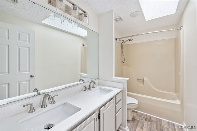 9645 Benbow Rd, North Chesterfield, VA 23235 - bathroom with toilet, wood finished floors, shower / washtub combination, double vanity, and a skylight