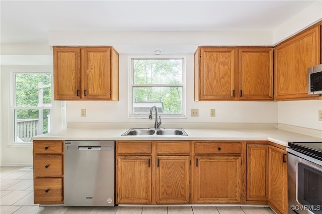 9645 Benbow Rd, North Chesterfield, VA 23235 - kitchen with appliances with stainless steel finishes, a sink, brown cabinets, and light countertops