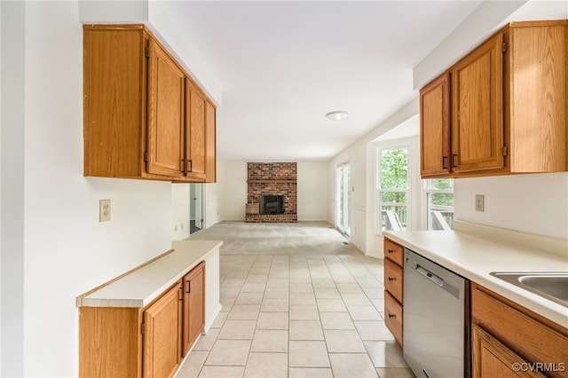 9645 Benbow Rd, North Chesterfield, VA 23235 - kitchen with stainless steel dishwasher, open floor plan, light countertops, a brick fireplace, and brown cabinets