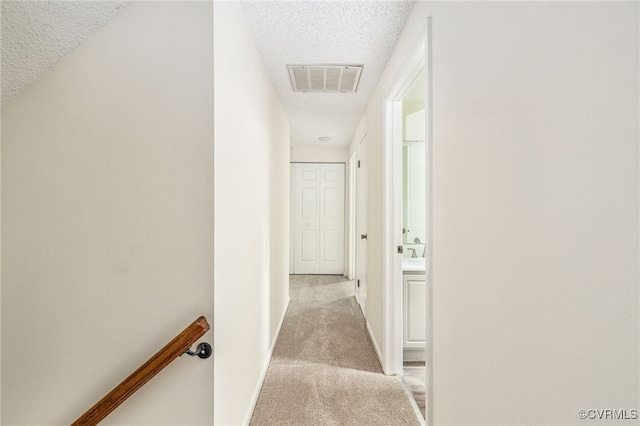 9645 Benbow Rd, North Chesterfield, VA 23235 - corridor with a textured ceiling, light carpet, an upstairs landing, and baseboards
