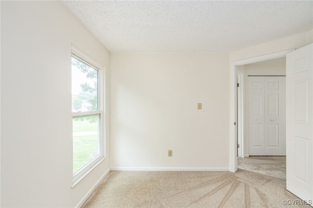 9645 Benbow Rd, North Chesterfield, VA 23235 - carpeted empty room featuring plenty of natural light, a textured ceiling, and baseboards