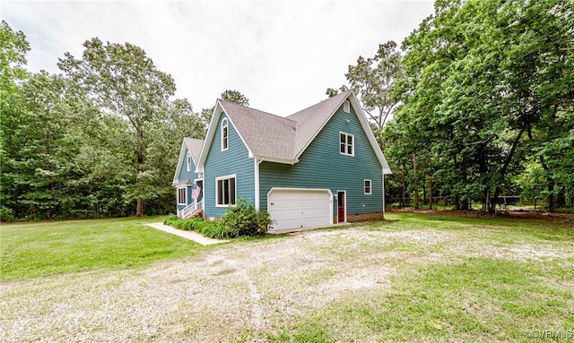 8011 Wood Dr, Disputanta, VA 23842 - view of home's exterior featuring driveway, roof with shingles, an attached garage, and a lawn