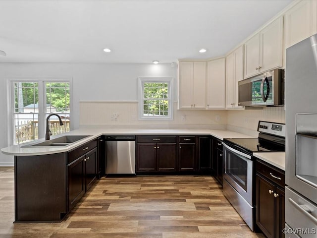 11660 Oakrise Pl, New Kent, VA 23124 - kitchen with appliances with stainless steel finishes, a sink, a peninsula, plenty of natural light, and recessed lighting