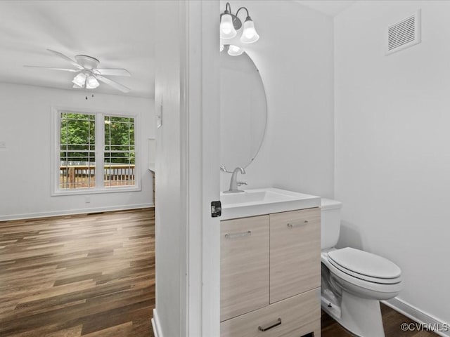 11660 Oakrise Pl, New Kent, VA 23124 - bathroom featuring vanity, a ceiling fan, wood finished floors, toilet, and baseboards