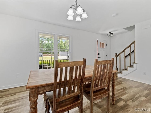 11660 Oakrise Pl, New Kent, VA 23124 - dining area featuring a chandelier, light wood-style floors, stairway, and baseboards