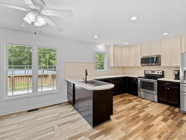 11660 Oakrise Pl, New Kent, VA 23124 - kitchen featuring stainless steel appliances, a sink, a peninsula, plenty of natural light, and recessed lighting