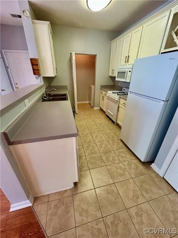 820 Brassie Ln Unit B, Glen Allen, VA 23059 - kitchen featuring white appliances, a sink, a textured ceiling, light tile patterned flooring, and baseboards