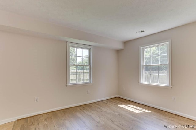 1928 Box St, Hampton, VA 23661 - empty room featuring wood finished floors, healthy amount of natural light, and baseboards