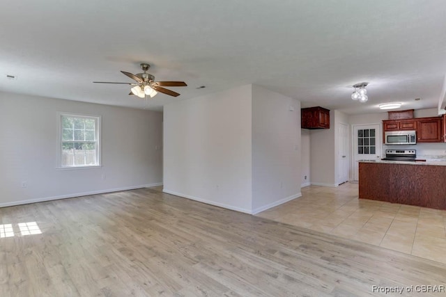 1928 Box St, Hampton, VA 23661 - unfurnished living room with baseboards, light wood finished floors, and a ceiling fan