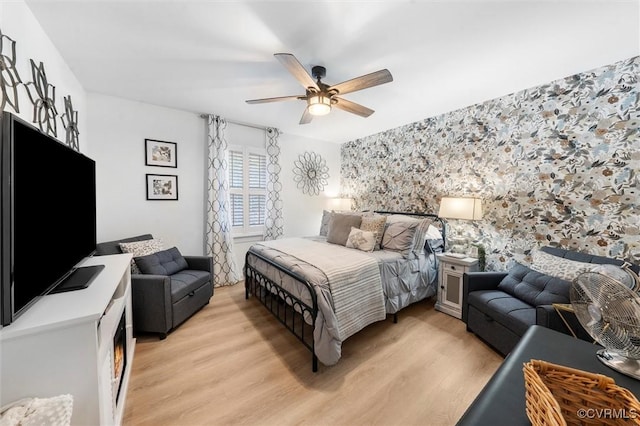 905 Manakin Rd, Midlothian, VA 23113 - bedroom featuring an accent wall, light wood finished floors, wallpapered walls, and a ceiling fan