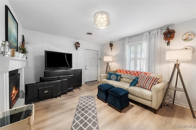905 Manakin Rd, Midlothian, VA 23113 - living area featuring wood finished floors, a warm lit fireplace, and baseboards