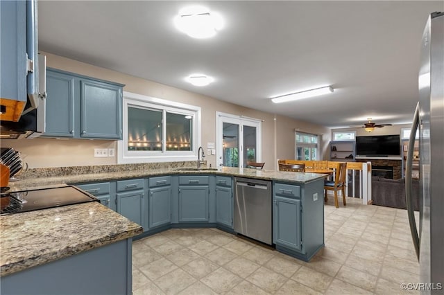 6305 Walnut Bend Ter, Midlothian, VA 23112 - kitchen featuring stainless steel appliances, a sink, blue cabinets, and a peninsula