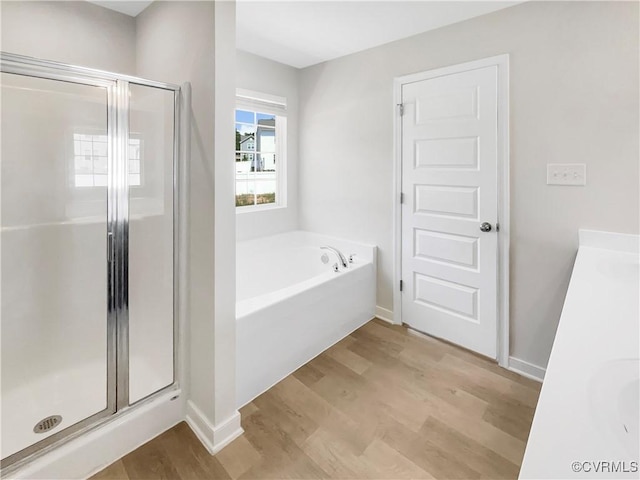 5812 Olas Ct, Richmond, VA 23224 - bathroom featuring a stall shower, a garden tub, wood finished floors, and vanity