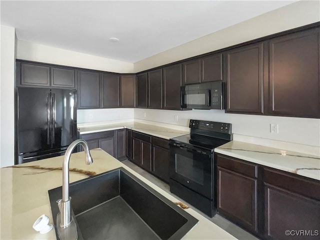 5812 Olas Ct, Richmond, VA 23224 - kitchen with black appliances, a sink, dark brown cabinetry, and light countertops