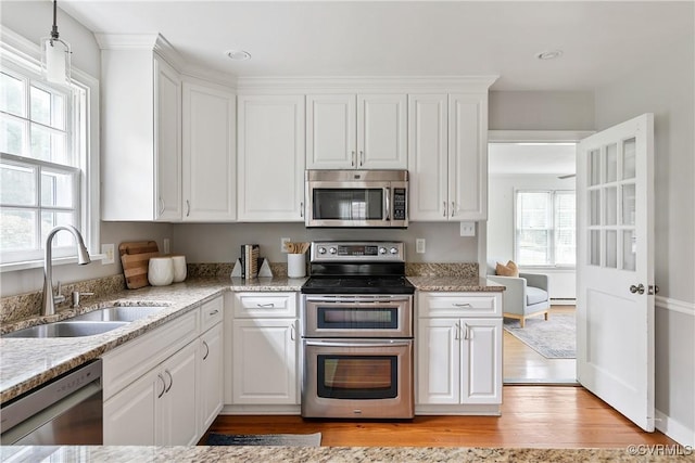 7625 Marilea Rd, Richmond, VA 23225 - kitchen featuring appliances with stainless steel finishes, a sink, white cabinetry, baseboard heating, and recessed lighting