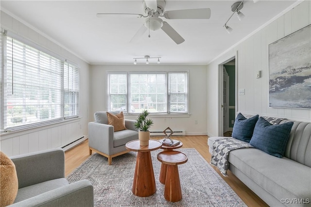 7625 Marilea Rd, Richmond, VA 23225 - living area featuring a baseboard heating unit, ornamental molding, track lighting, a baseboard radiator, and light wood finished floors