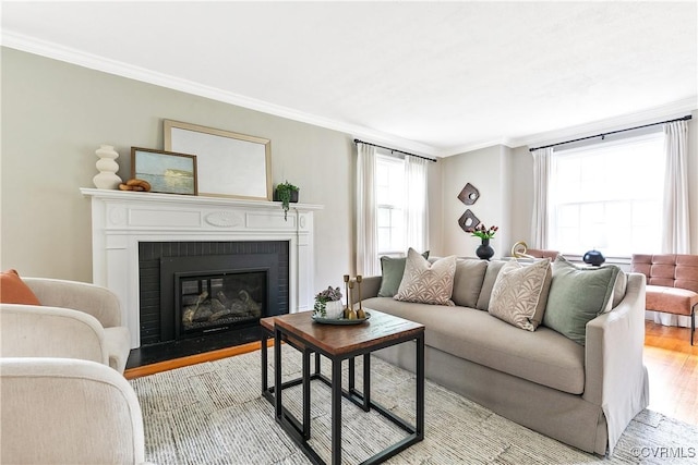 7625 Marilea Rd, Richmond, VA 23225 - living area featuring light wood-type flooring, a brick fireplace, and crown molding