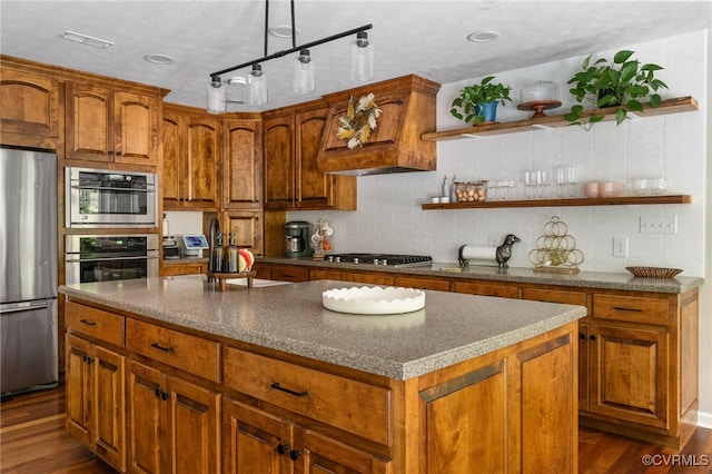 160 Woodland Trl, West Point, VA 23181 - kitchen featuring appliances with stainless steel finishes, dark wood-style floors, brown cabinets, and decorative backsplash