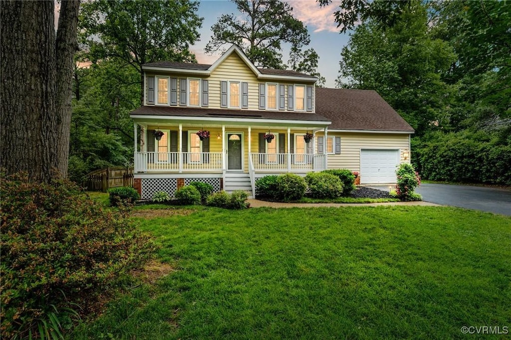 1513 Crawford Wood Dr, Midlothian, VA 23114 - colonial-style house featuring asphalt driveway, a porch, a garage, and a front lawn