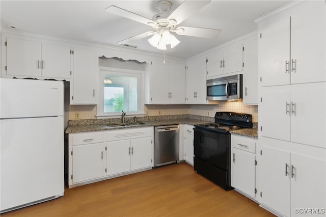 11440 Bienvenue Rd, Rockville, VA 23146 - kitchen featuring stainless steel appliances, a sink, tasteful backsplash, light wood finished floors, and white cabinetry