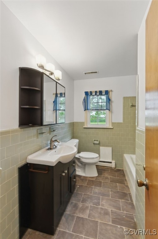 11440 Bienvenue Rd, Rockville, VA 23146 - full bath featuring tile walls, vanity, wainscoting, toilet, and healthy amount of natural light