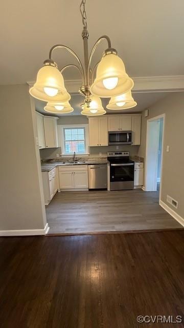 9014 Weldon Dr, Henrico, VA 23229 - kitchen featuring stainless steel appliances, white cabinetry, baseboards, a sink, and dark wood-style floors