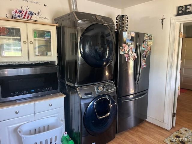 272 Deer Run Trl, Saint Stephens Church, VA 23148 - laundry room featuring stacked washer and clothes dryer and light wood-style flooring