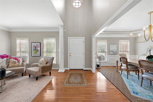 13212 Railey Hill Dr, Midlothian, VA 23114 - entryway featuring ornamental molding, decorative columns, light wood-style flooring, plenty of natural light, and a chandelier