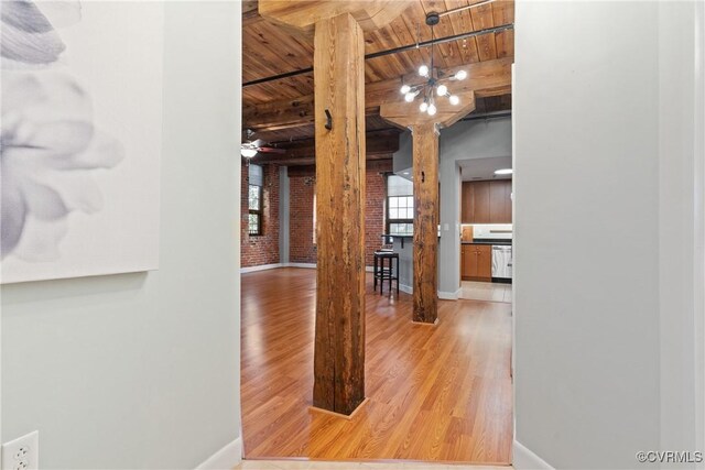 251 Rocketts Way Unit 210, Henrico, VA 23231 - corridor featuring wood ceiling with exposed beams, wood finished floors, baseboards, and brick wall