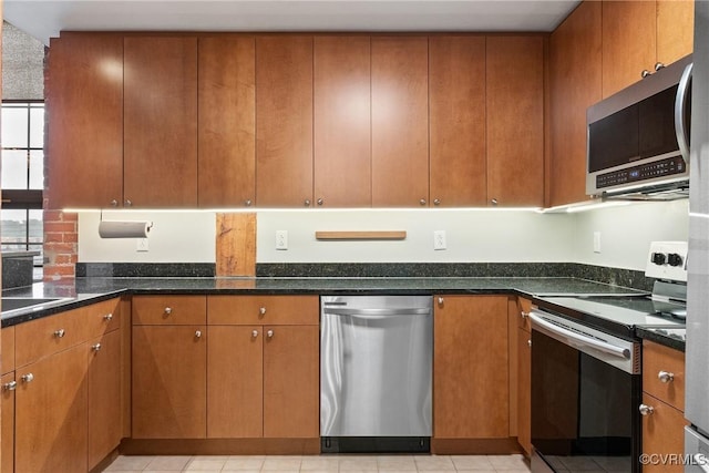 251 Rocketts Way Unit 210, Henrico, VA 23231 - kitchen featuring appliances with stainless steel finishes, dark stone counters, and brown cabinets