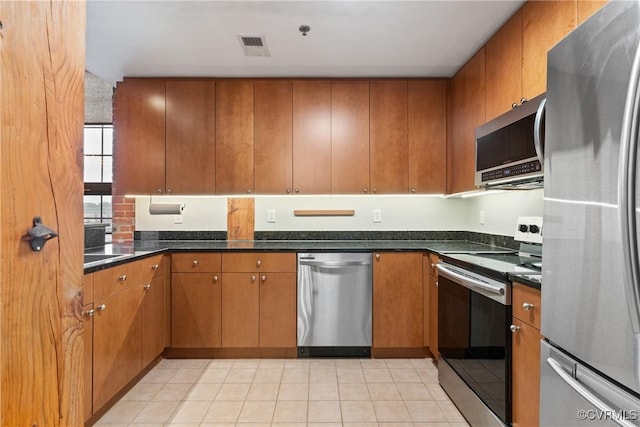 251 Rocketts Way Unit 210, Henrico, VA 23231 - kitchen featuring stainless steel appliances, brown cabinetry, and light tile patterned floors