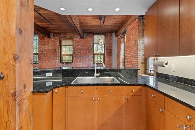 251 Rocketts Way Unit 210, Henrico, VA 23231 - kitchen featuring a sink, brick wall, wood ceiling with exposed beams, dark stone countertops, and decorative light fixtures
