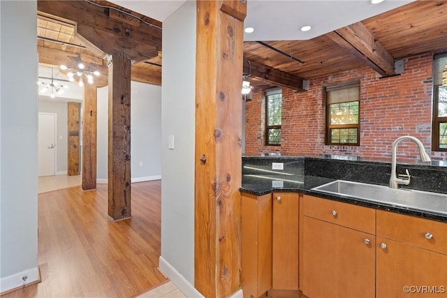 251 Rocketts Way Unit 210, Henrico, VA 23231 - kitchen featuring wooden ceiling with exposed beams, a sink, light wood-type flooring, baseboards, and brick wall