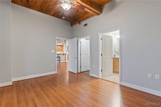 251 Rocketts Way Unit 210, Henrico, VA 23231 - unfurnished bedroom featuring wood ceiling with exposed beams, a high ceiling, light wood-style flooring, baseboards, and ensuite bathroom